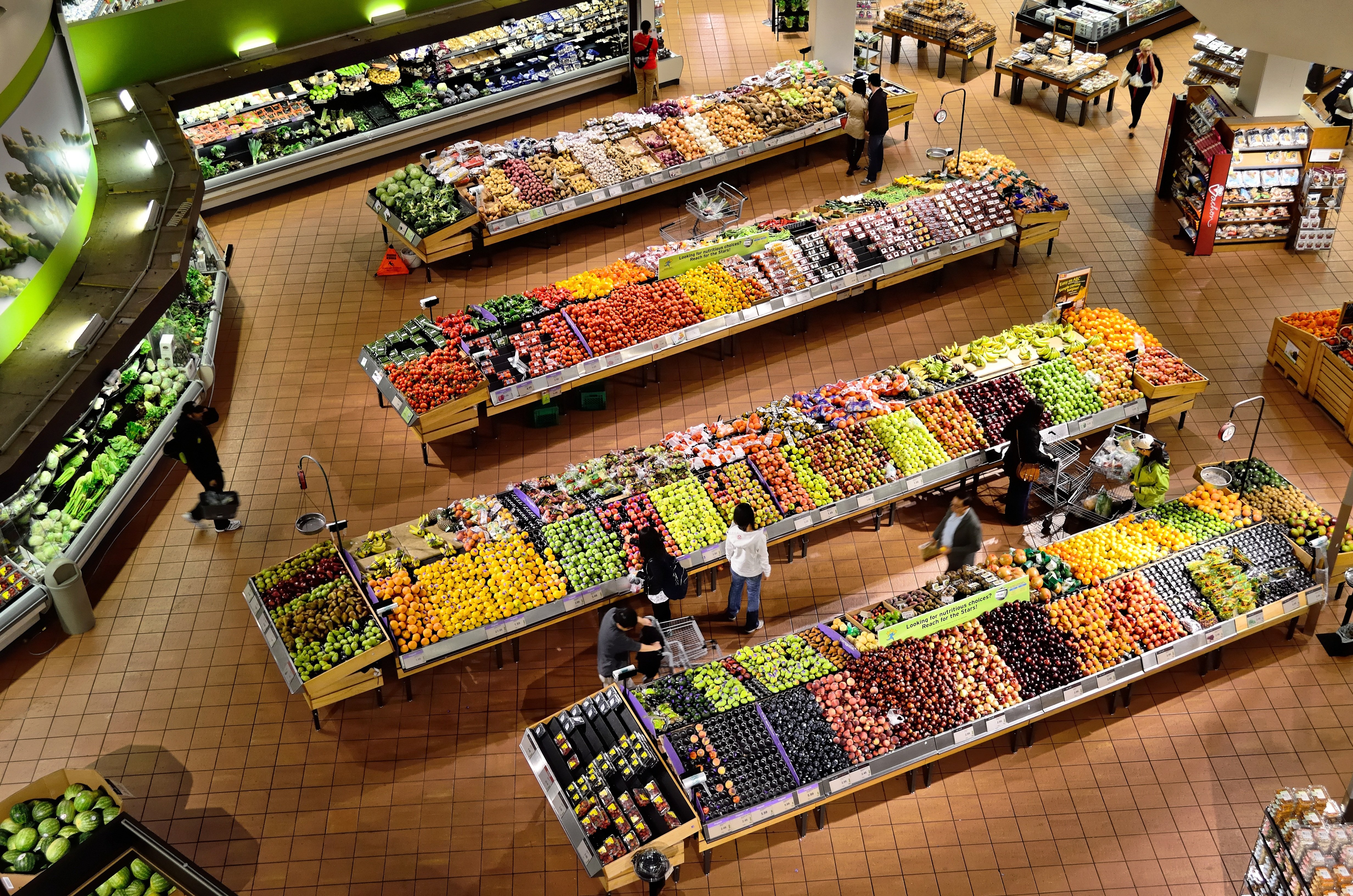 Woman shopping in grocery store with phone
